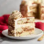 Tiramisu Cake slice with mascarpone frosting and cocoa powder