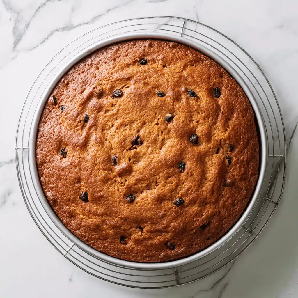 Pouring applesauce cake batter into a baking pan