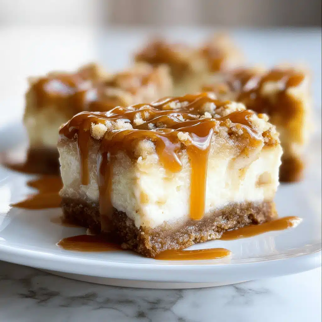 Caramel Apple Cheesecake Bars with caramel drizzle on a rustic kitchen counter