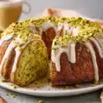 Pistachio cake baked in a Bundt pan with vanilla glaze and chopped pistachios
